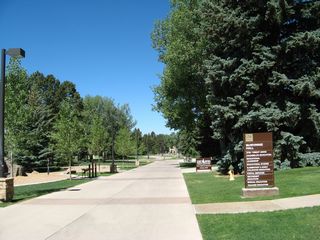 A wide, concrete walkway provides access from Willett Drive and 15th Street west into the University of Wyoming. This view looks west near McWhinnie Hall. Near the Willett Drive entrance is Half Acre Gym and views toward Prexy's Pasture, the central quad on the University of Wyoming campus.
