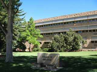 The College of Education, with its "Go forth and teach this people" inscription is just north of the walkway. The sandstone bricks found on many of the central buildings on the campus was quarried in southeastern Wyoming and is a design theme for many buildings, going back to the original design of the university's Old Main.