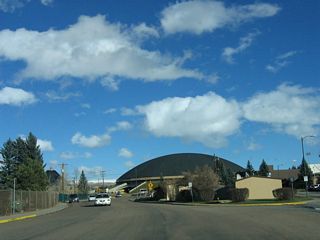 The driveways on the right (south) side of Willet Drive provide access to several fraternity houses as well as the University of Wyoming Law School. The large domed building looming ahead on eastbound Willet Drive is the Arena-Auditorium, which is home to the University of Wyoming college basketball team.