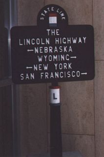 At each state line along the Lincoln Highway were markers such as this one that provided the highway emblem at the top, the name "Lincoln Highway" at the middle, the two states immediately below the name, and the two endpoints of the highway (New York City to the east and San Francisco to the west). These signs were found at each state line as far back as 1917. Today, the marker that used to be located at Pine Bluffs is now found in the Wyoming Department of Transportation Headquarters in Cheyenne; this photo shows that signage from an earlier era of vehicular transportation in Wyoming.