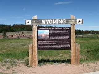 Aside from the exhibits found within the visitors center of the Summit Rest Area are several other Lincoln Highway artifacts and memorials on the grounds near the parking lot. The Lincoln Highway, which predates both Interstate 80 and U.S. 30 but came after the railroad, was established by Carl Fisher in 1913 to define a transcontinental route that would connect New York City with San Francisco. The goal was to have the road ready for the 1915 Panama-Pacific International Exposition in San Francisco, and most of the road was mapped by that time. However, the Lincoln Highway was barely passable for all of its original 3,389 miles, especially in western states where it passed through unpopulated areas. The road was gradually improved, and even President Eisenhower passed over portions of the Lincoln Highway as part of a miliary convoy, causing him to become interested in good roads. The Lincoln Highway eventually became part of the U.S. Highway System, and the majority became U.S. 30 from Utah to Pennsylvania. This sign, which is posted adjacent to the Henry Bourne Joy Monument, offers an historical overview of the route.
