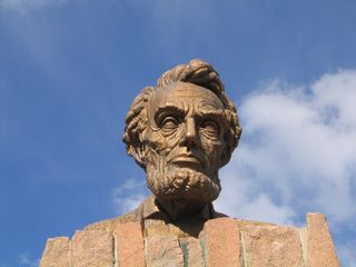Robert Russin, who was an art professor at the University of Wyoming, designed and created the 13.5-foot tall bronze bust of Lincoln in 1959 to celebrate the president's 150th birthday. According toGreetings from the Lincoln Highwayby Brian Butko (2005, pg. 189), Russin used ten tons of clay to create the bust, and the bust was cast in 30 pieces in Mexico City (which has a more favorable climate for such construction than Wyoming). The bust was transported from Mexico to Wyoming and placed atop a 35-foot tall base made of granite. The granite base is hollow, allowing for ladders and lightning rods inside. Of course, the memorial only lasted ten years in its original location at the 8,835-foot summit; it was moved in 1969 to its current location at the 8,640-foot summit.