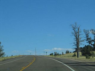An extant section of old U.S. 30 still serves as a service road along the south side of Interstate 80 between the Wyoming 210/Happy Jack Road interchange (Exit 323) and Vedauwoo Road interchange (Exit 329). The former U.S. route follows the second generation (1930s era) of Lincoln Highway over the top of Sherman Hill, ascending to an elevation (8,835 feet) higher than that of the Interstate 80 Summit Rest Area (8,640 feet), which is regarded today as the highest point on Interstate 80, U.S. 30, and the Lincoln Highway.