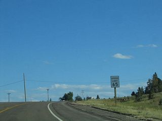 On this two-lane highway, the old Lincoln Highway carries a 65 mile per hour speed limit, even as the highway continues to gain elevation to the top of Sherman Hill. There is a total of 195 feet in elevation that separate the two summits of Interstate 80/U.S. 30 and Old U.S. 30. This service road is the 1930s alignment of the Lincoln Highway, but it is not the original route over Sherman Hill. Another alignment from the 1920s also crosses the summit, but it is now a gravel road. Consult a good Lincoln Highway guidebook to locate this alignment as well as the Harriman Road alignment via Wyoming 218 southwest to U.S. 287 at Tie Siding.