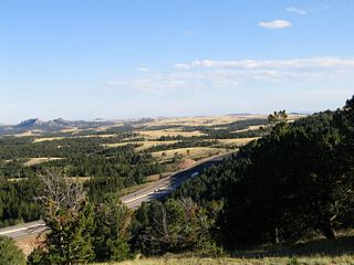 This is an example of the scenery to the north and northeast of the Lincoln Highway. The Vedauwoo Rocks, which are famous with rock climbers throughout the West, dominate the northern view, while the great plains spread out to the east. Only a surprisingly few trees reside in the valleys, basins, and canyons of Sherman Hill; the rest of the land is devoid of tall vegetation. Wyoming winds blow through the area routinely, and this constant flow of air does not promote tree growth.