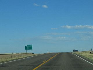 The advance signage for Exit 329, Vedauwoo Road (Forest Service Road 700) is visible from the Lincoln Highway service road.