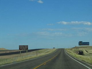 A brown guide sign indicates that several attractions, including the Medicine Bow National Forest Recreation Areas in Vedauwoo that are north of Interstate 80 and the Ames Monument south of Interstate 80 are both accessible via Exit 329. Just prior to reaching Vedauwoo Road, old U.S. 30 meets Blair Road.